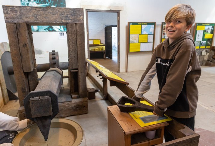 A child looking at objects at Saltford Brass Mill