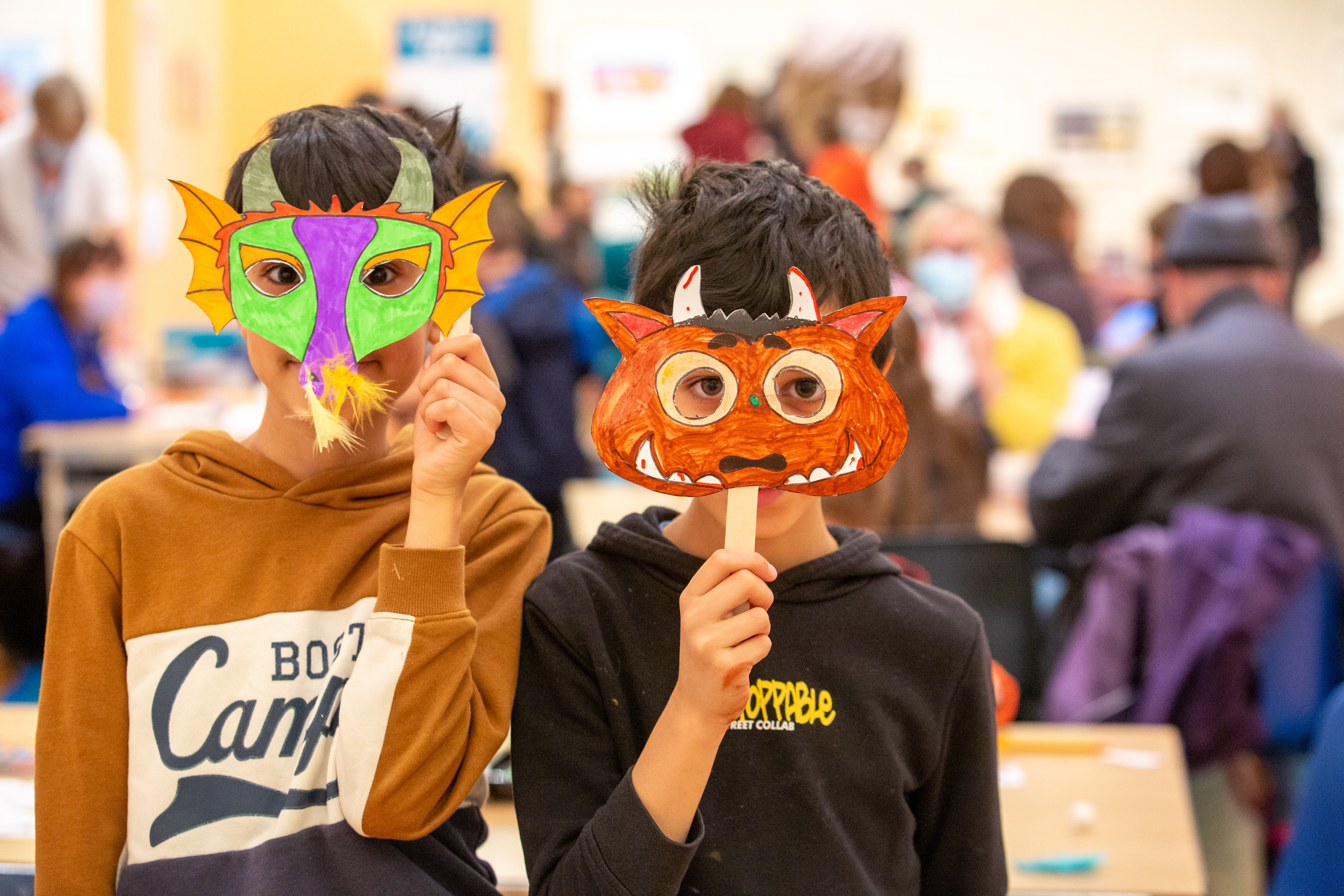 Image: Children wearing masks they created at a craft activity