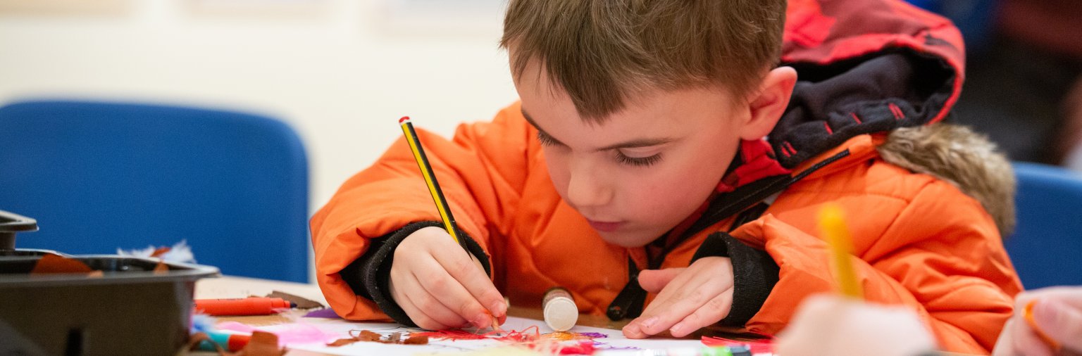 Image: A child taking part in a craft activity