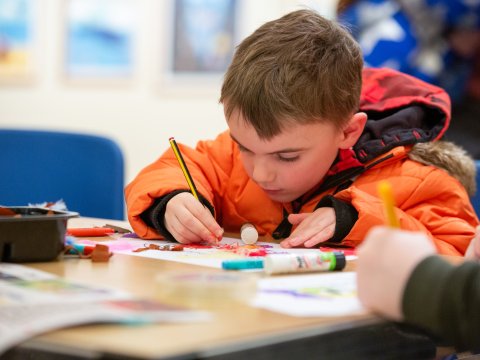 Image: A child taking part in a craft activity